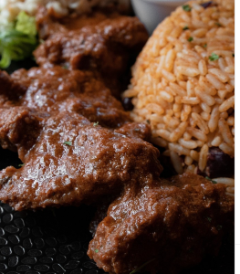 Stewed steak (Steak na wea) with funchi fries, plantains,morro rice and veggie mix and plantains