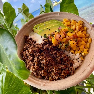 Ground beef nacho bowl with cilantro rice, corn and tomatoes, sour cream and avocado