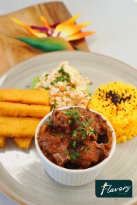 Goat stew (Kabritu) with funchi fries, rice, plantains and veggies