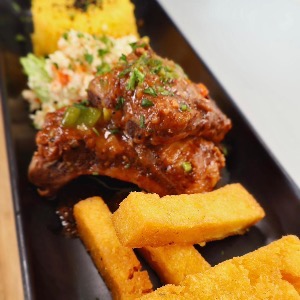 Stewed ribs (ribs stoba)with funchi fries, plantains,morro rice and veggie mix and plantains