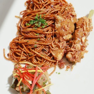 Bami with chicken sate and cucumber in vinegar salad