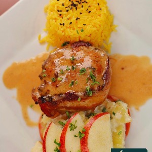 Chicken medallions with bacon, yellow rice and an apple salad