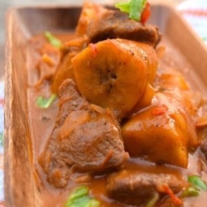 Banana stoba with beef and funchi, plantains and a carrot salad
